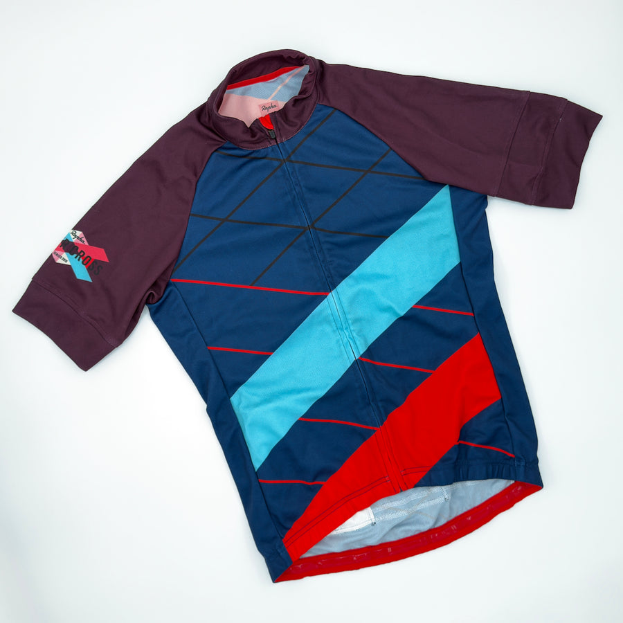 Rapha Men's Supercross Jersey in navy, angled front view with plum raglan sleeves