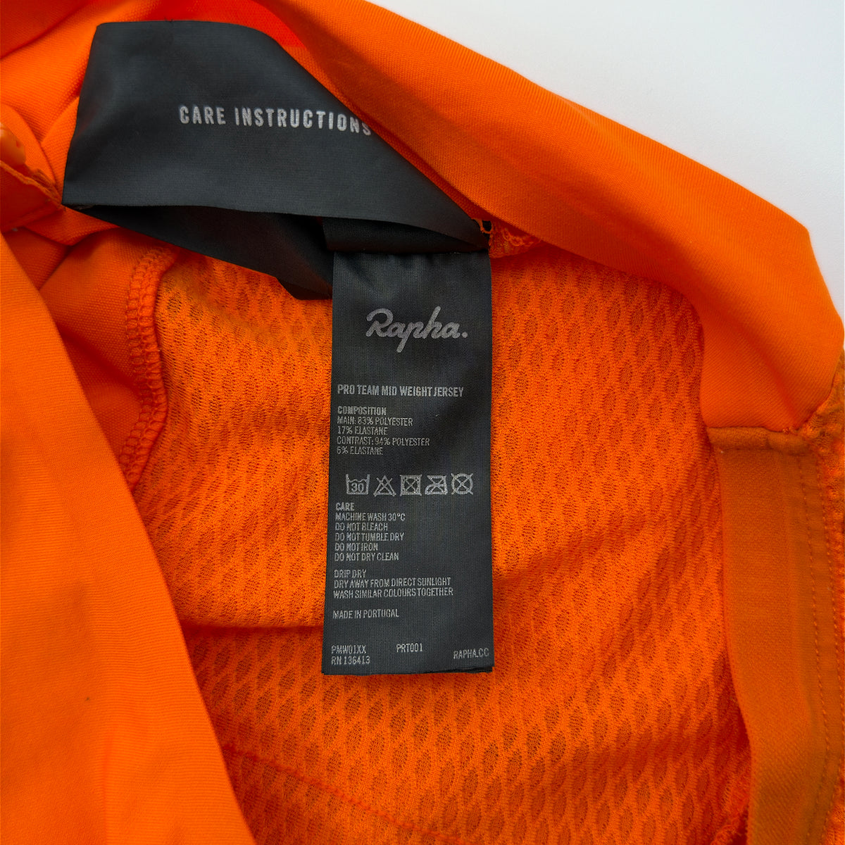 Rapha Pro Team Midweight Jersey care label showing composition and product code PMW01XX