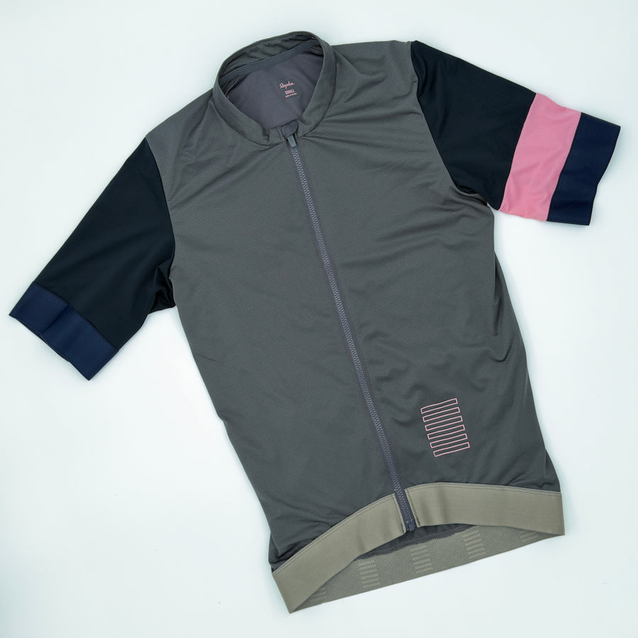 Rapha Men's Pro Team Training Jersey angled front view showing pink and navy cuff banding
