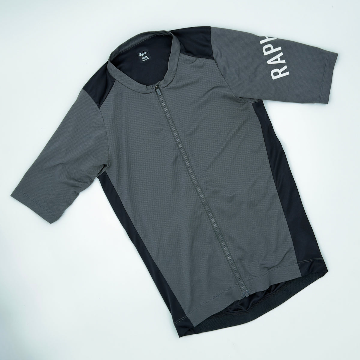 Rapha Men's Pro Team Training Jersey angled front view showing waffle-textured fabric and white RAPHA sleeve print