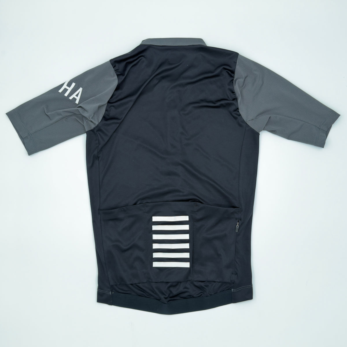 Rapha Men's Pro Team Training Jersey rear view showing three pockets, zipped valuables pocket and white bar print