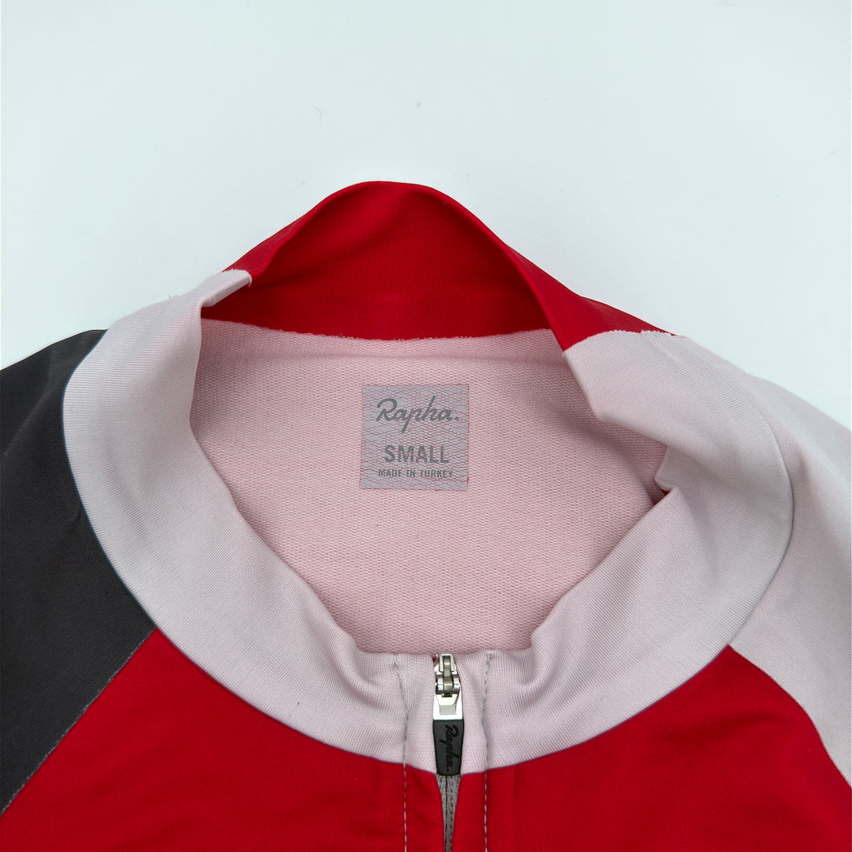 Rapha Trade Team Jersey neck label reading Small, Made in Turkey, with collar and zip garage