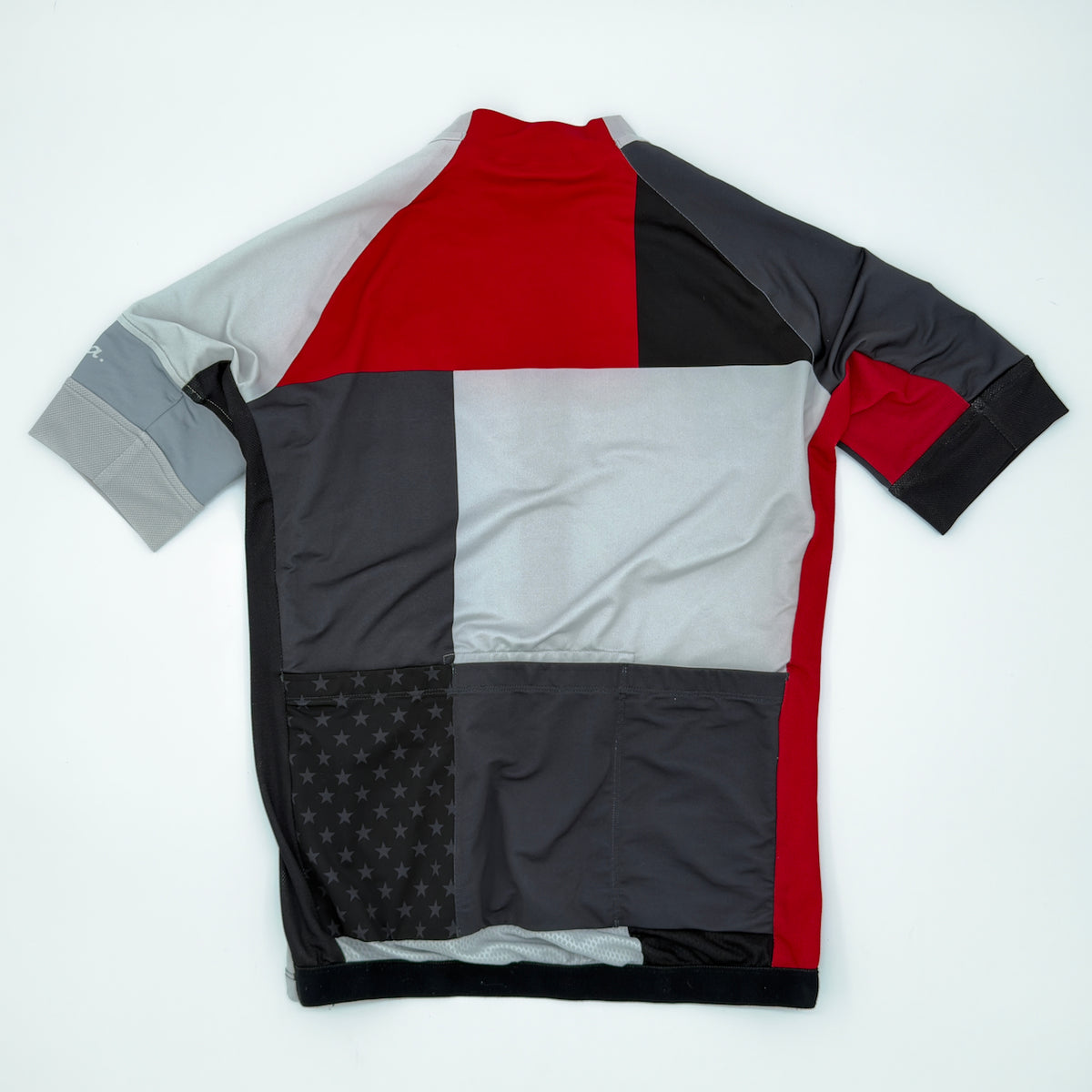 Rapha Trade Team Jersey rear view showing three pockets and star print across the pocket panel