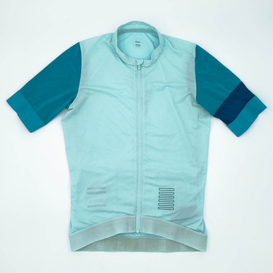 Rapha Pro Team Training Jersey angled front showing teal sleeves and petrol cuff band (alternate view)