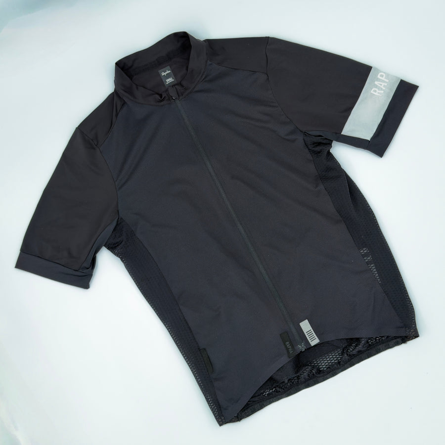 Rapha Pro Team Climber's Jersey angled front showing open honeycomb mesh side panels and reflective sleeve armband