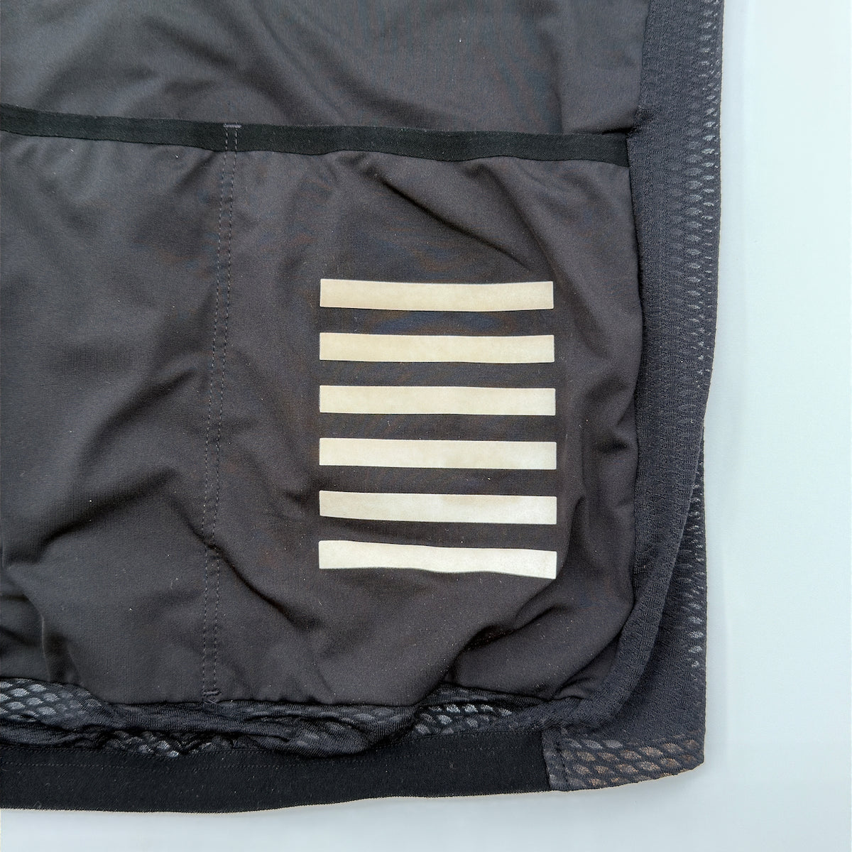 Close-up of the rear pocket reflective bar print showing slight cream discolouration with age