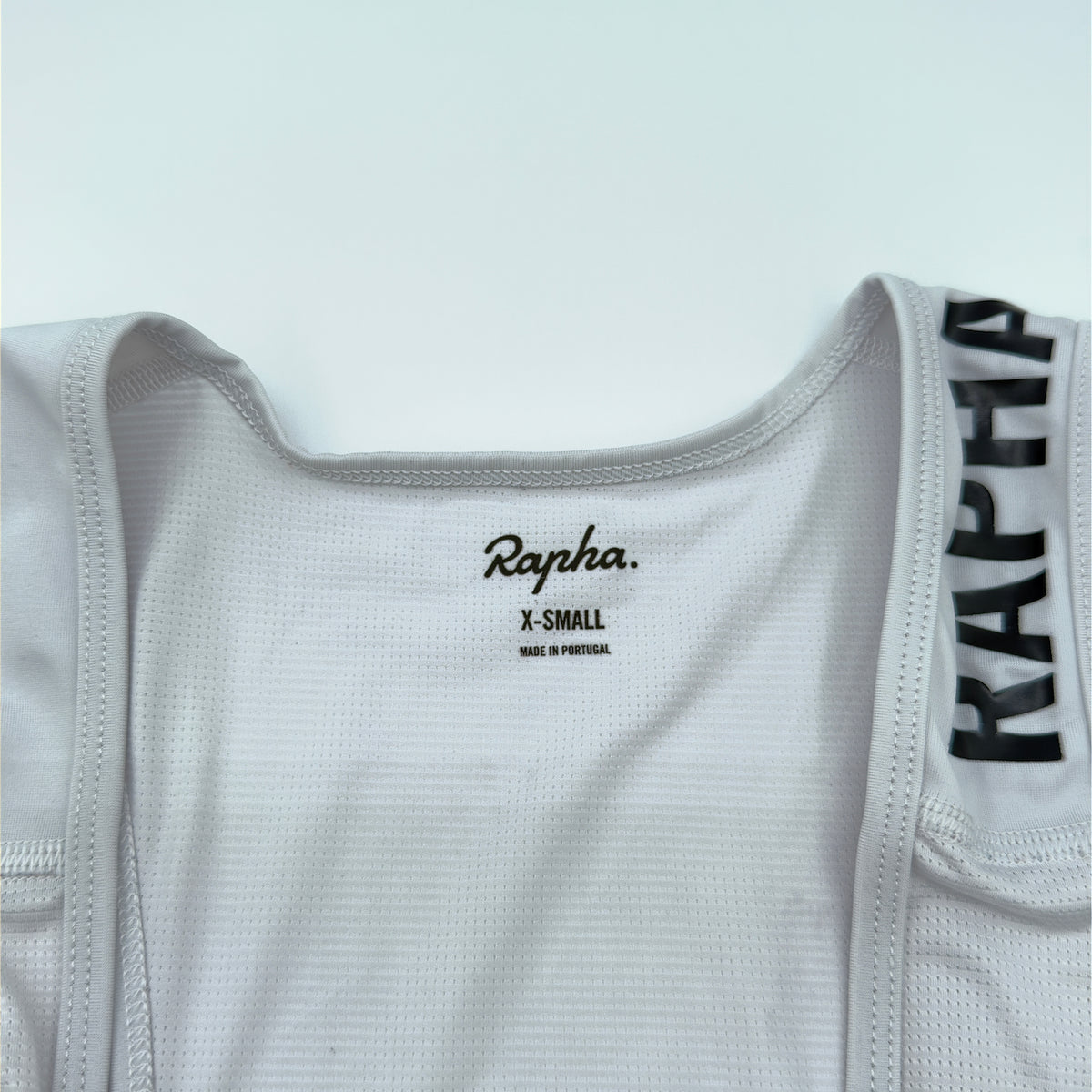 Rapha size label reading X-Small, made in Portugal, on the white mesh bib upper