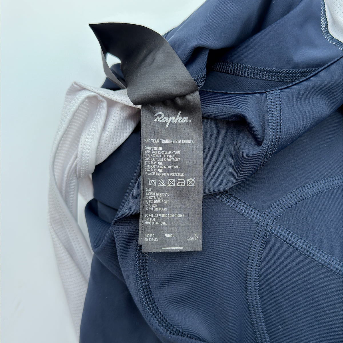 Rapha care label confirming Pro Team Training Bib Shorts, recycled nylon composition and made in Portugal