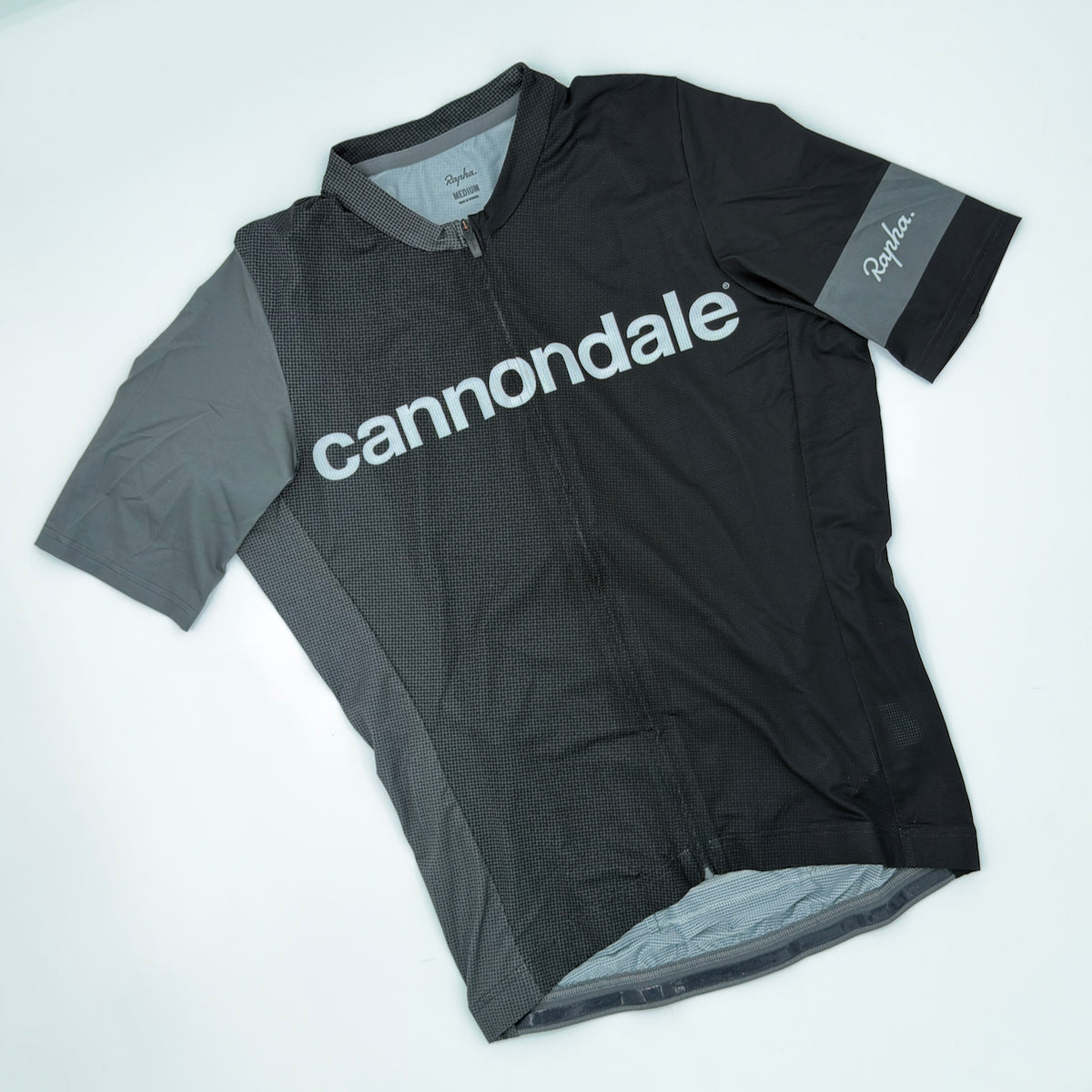 Rapha x Cannondale Pro Team Lightweight Jersey angled front showing grey cannondale wordmark and contrast shoulder panel