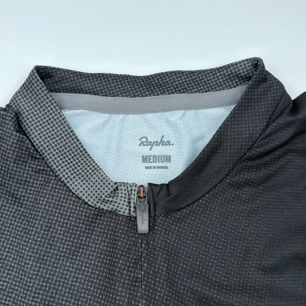 Rapha size label reading Medium, made in Romania, at the jersey collar