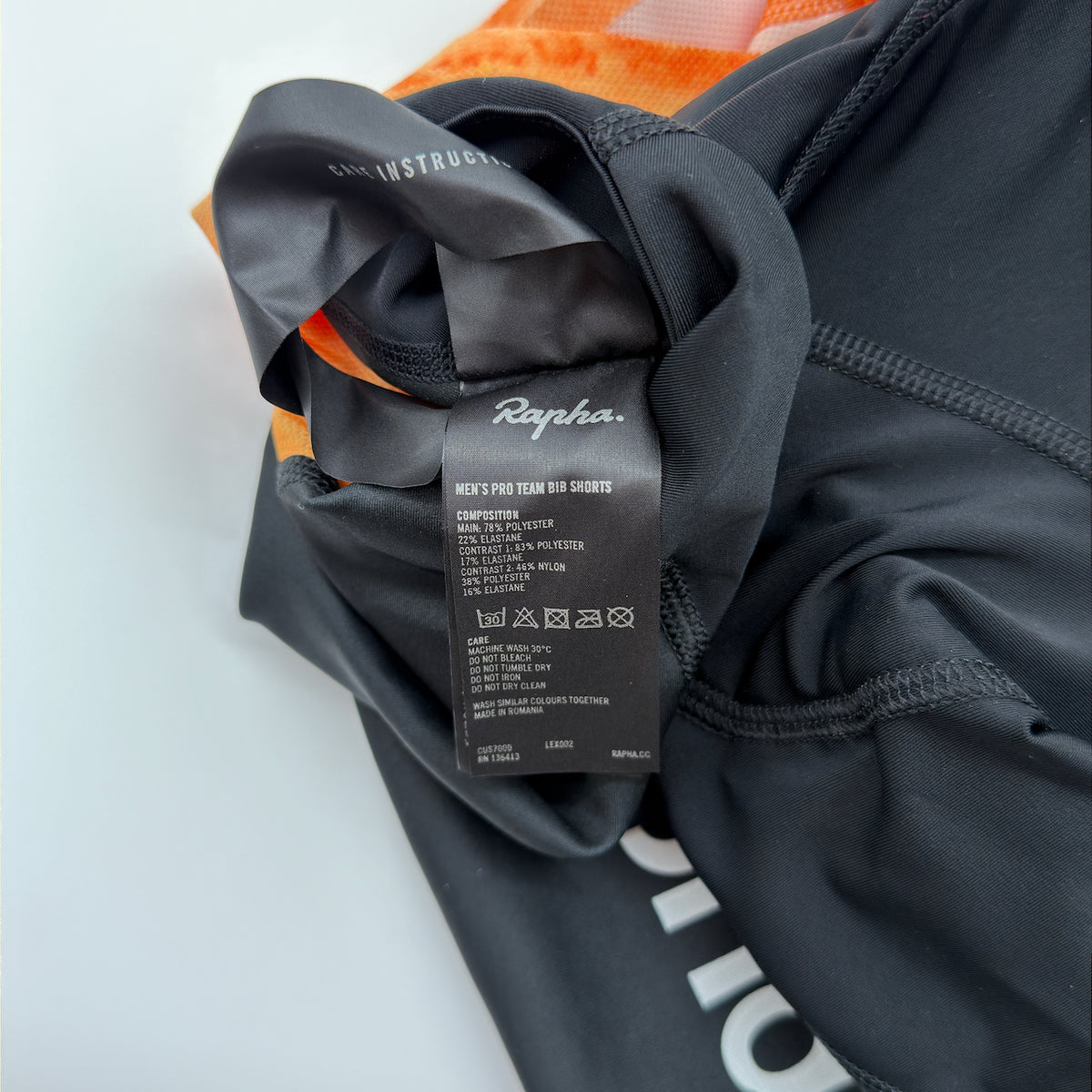 Rapha care label confirming Men's Pro Team Bib Shorts composition and made in Romania