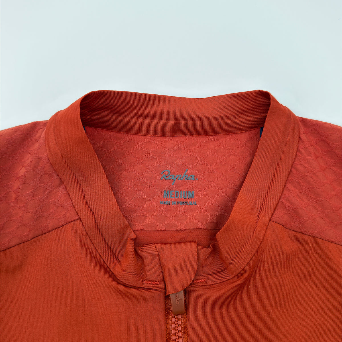 Rapha size label reading Medium, made in Portugal, on the hexagonal jacquard collar lining