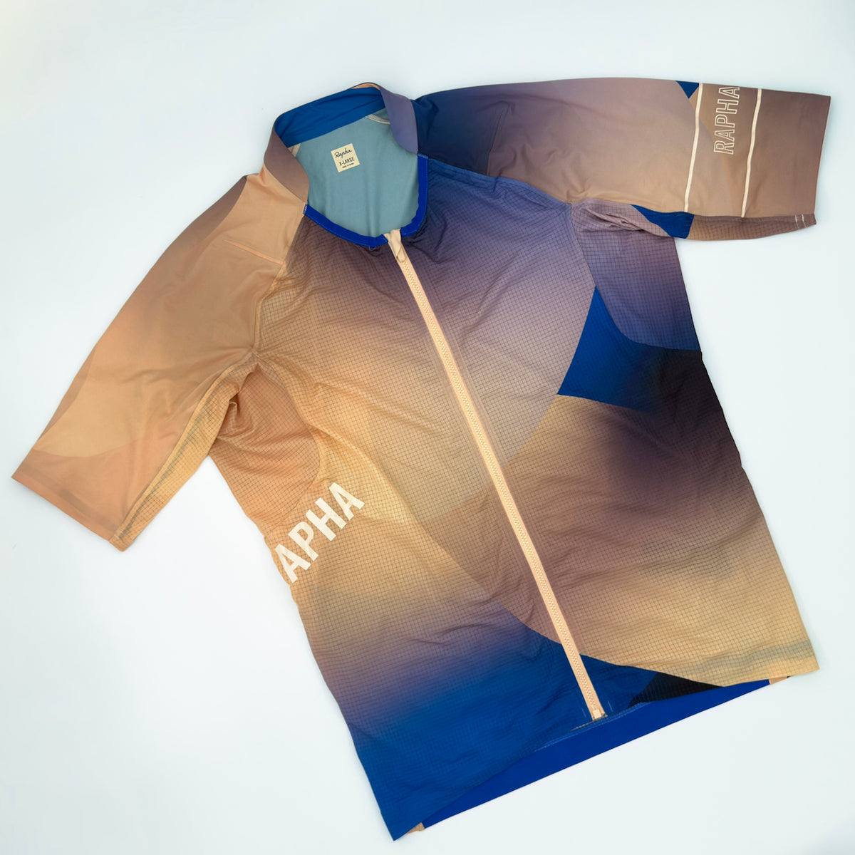 Rapha Pro Team Lightweight Jersey Surface Print angled front showing sand to cobalt gradient and diagonal RAPHA