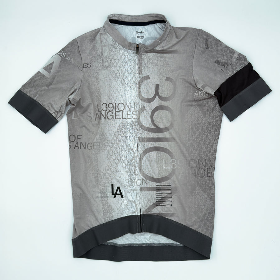 Rapha L39ION of Los Angeles Pro Team Training Jersey angled front showing all-over type print and charcoal cuff bands (alternate view)