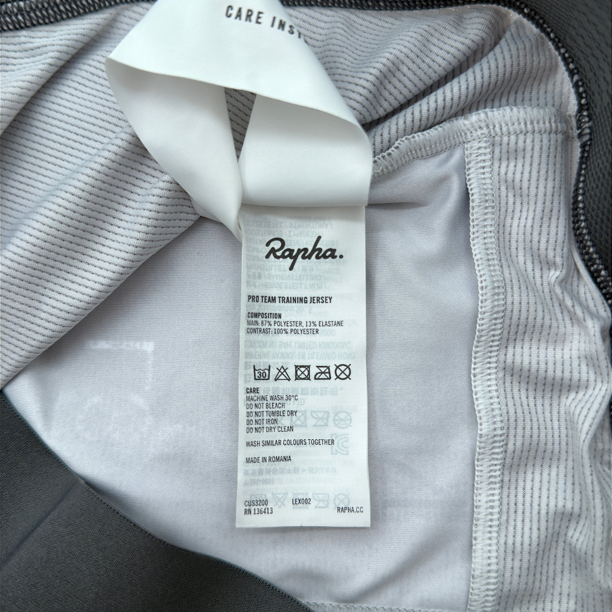 Rapha care label confirming Pro Team Training Jersey composition and made in Romania