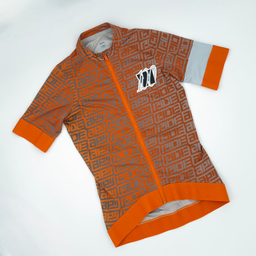 Rapha Women's 100 Pro Team Training Jersey angled front showing orange maze print and grey sleeve cuff