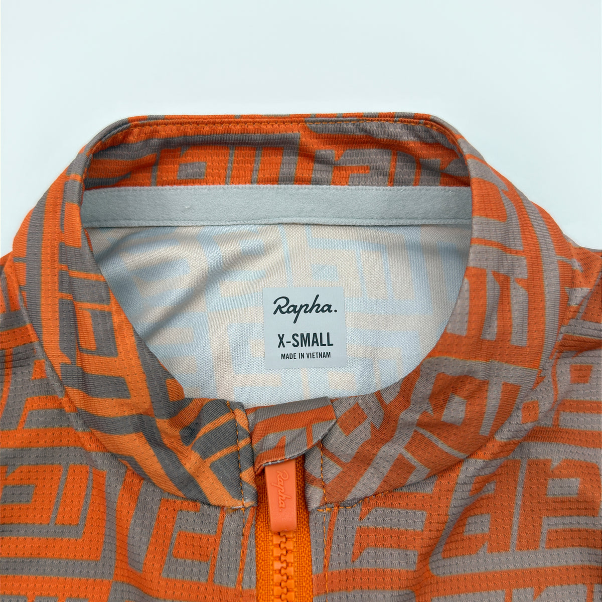 Rapha size label reading X-Small, made in Vietnam, at the collar with maze print visible