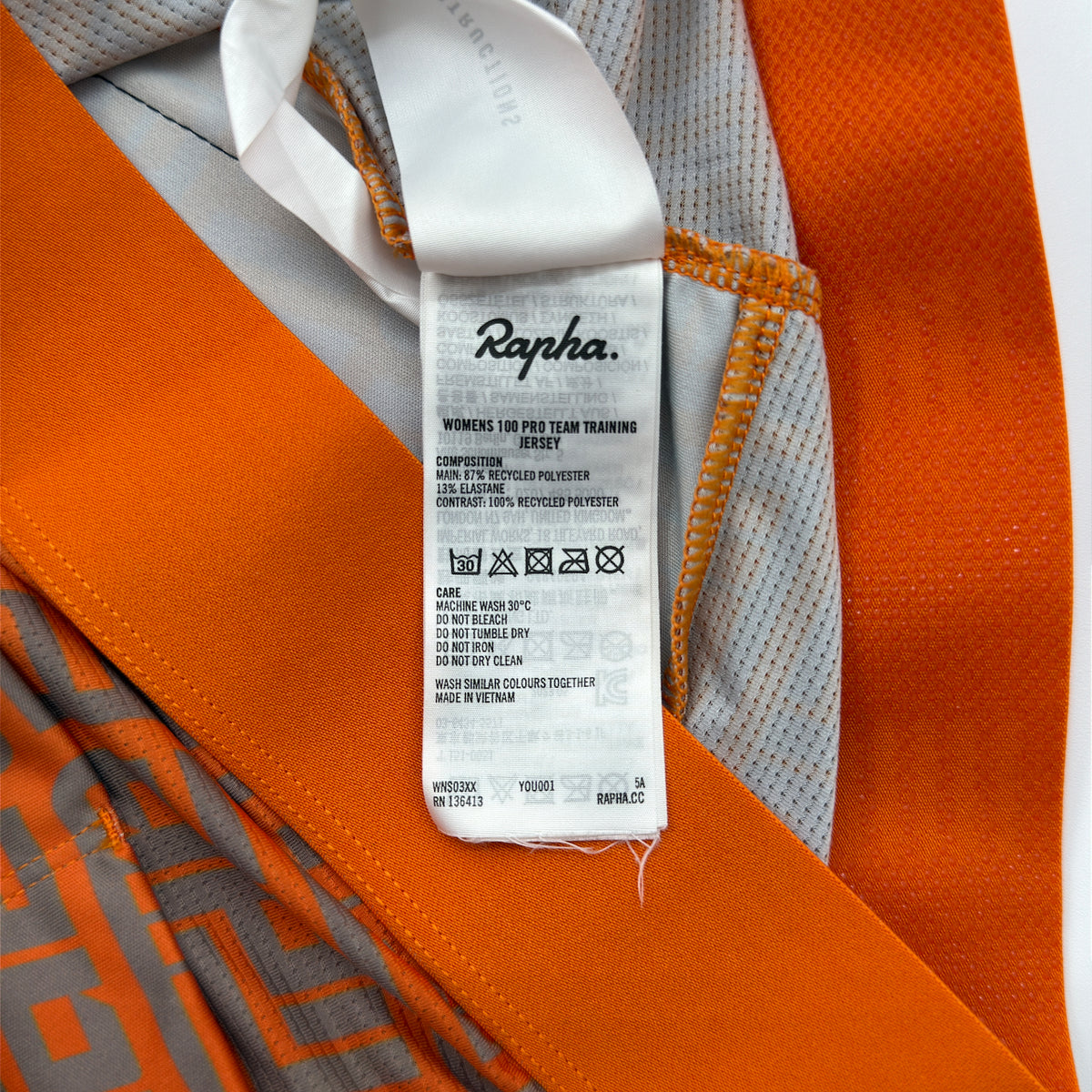 Rapha care label confirming Women's 100 Pro Team Training Jersey, recycled polyester composition and made in Vietnam