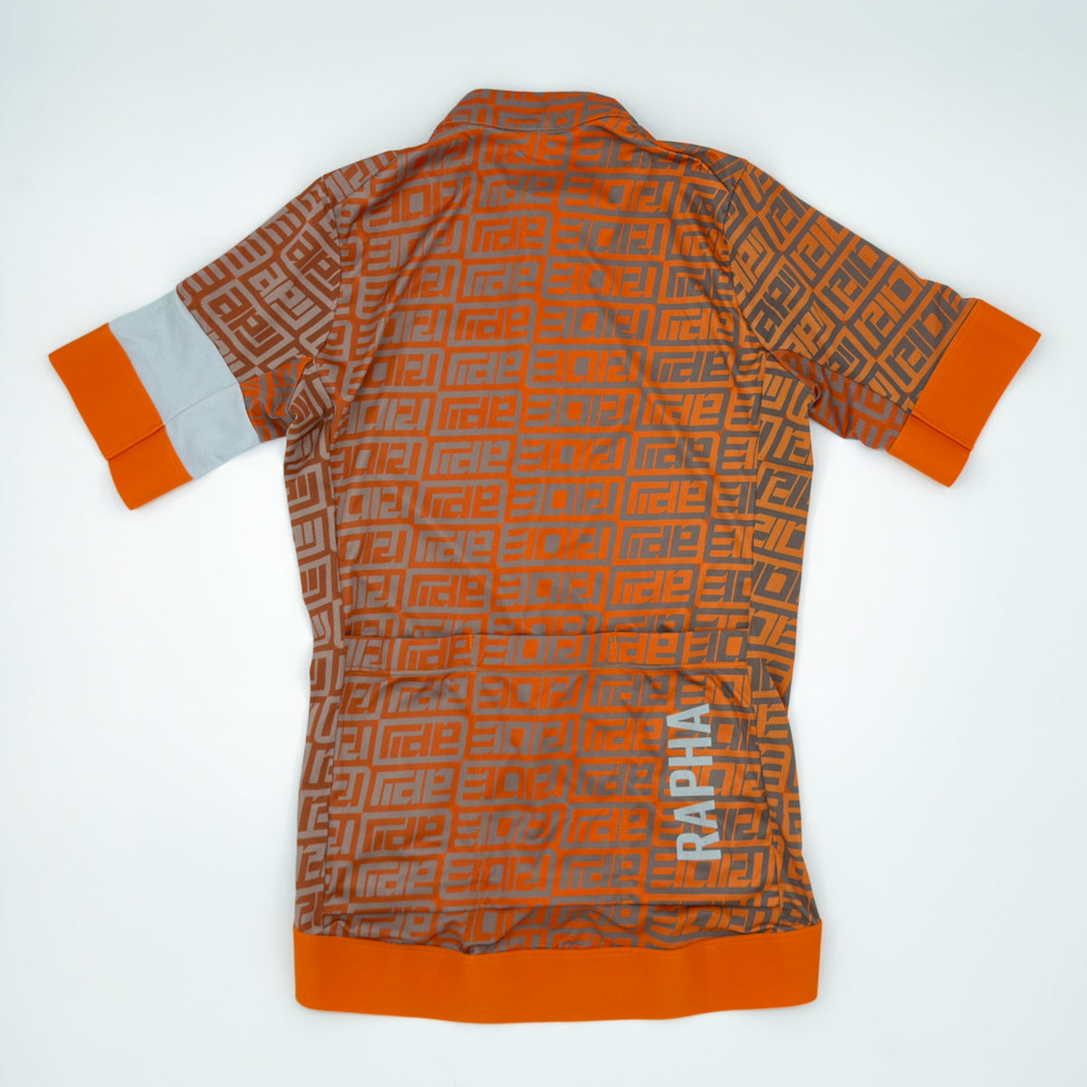 Rapha Women's 100 Pro Team Training Jersey rear view showing three pockets and RAPHA hem print