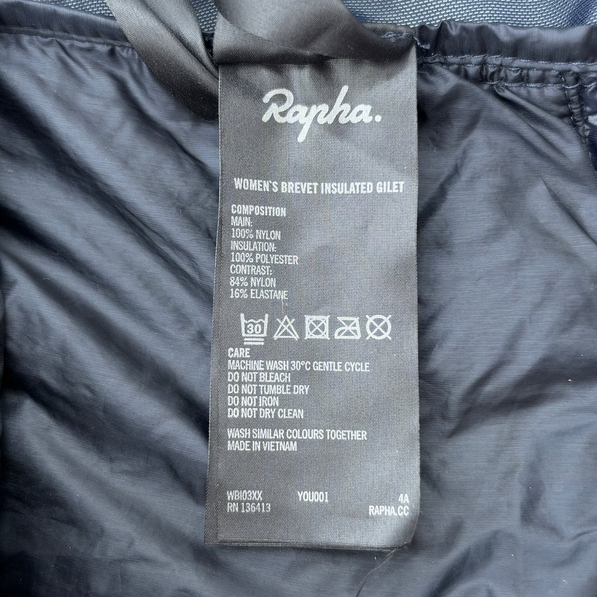 Care label showing Women's Brevet Insulated Gilet composition and wash instructions