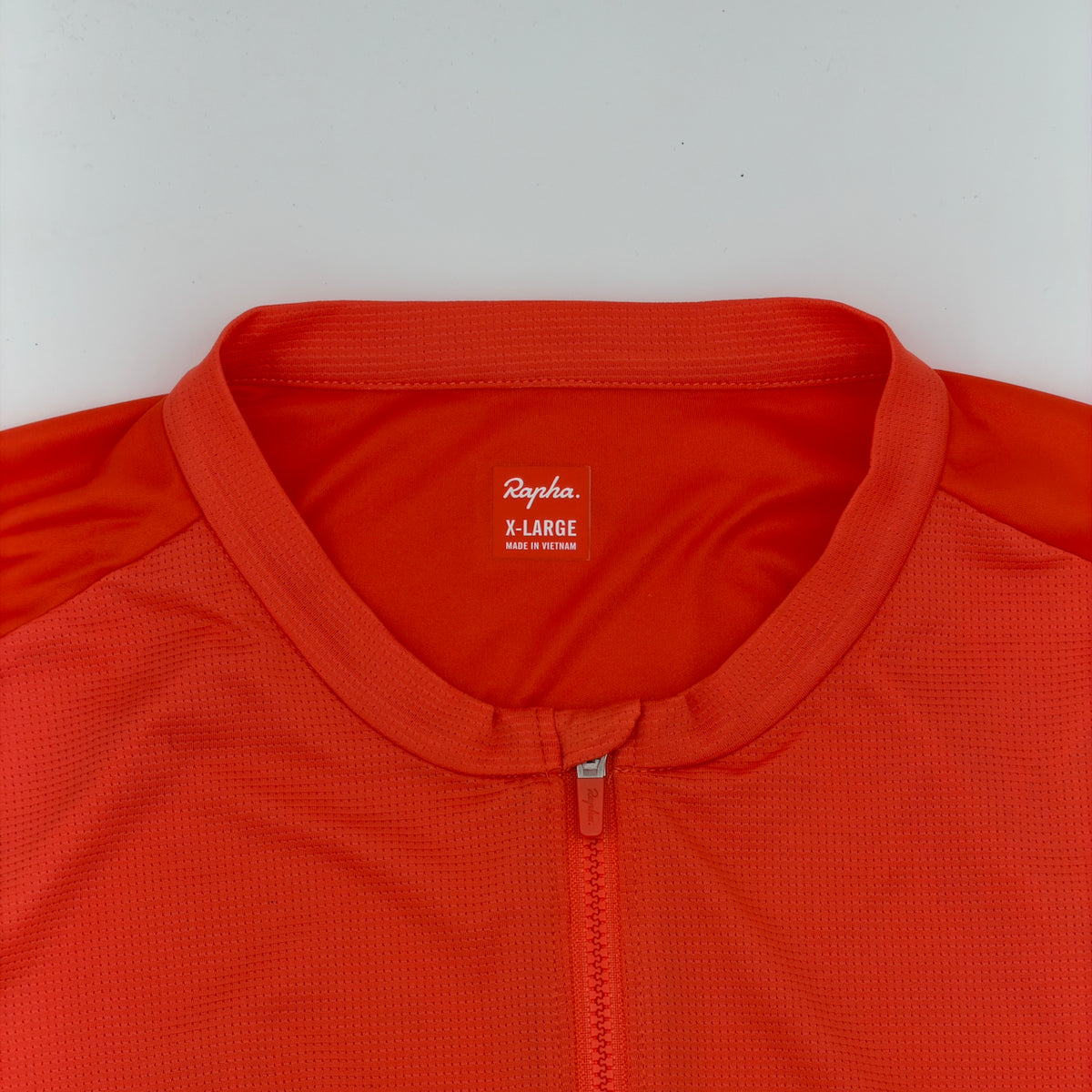 Rapha neck label confirming size X-Large, made in Vietnam, with waffle-textured fabric visible