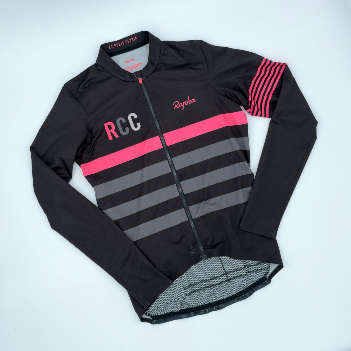 Angled front view showing RCC wordmark, hi-vis pink chest band and graduated grey stripes