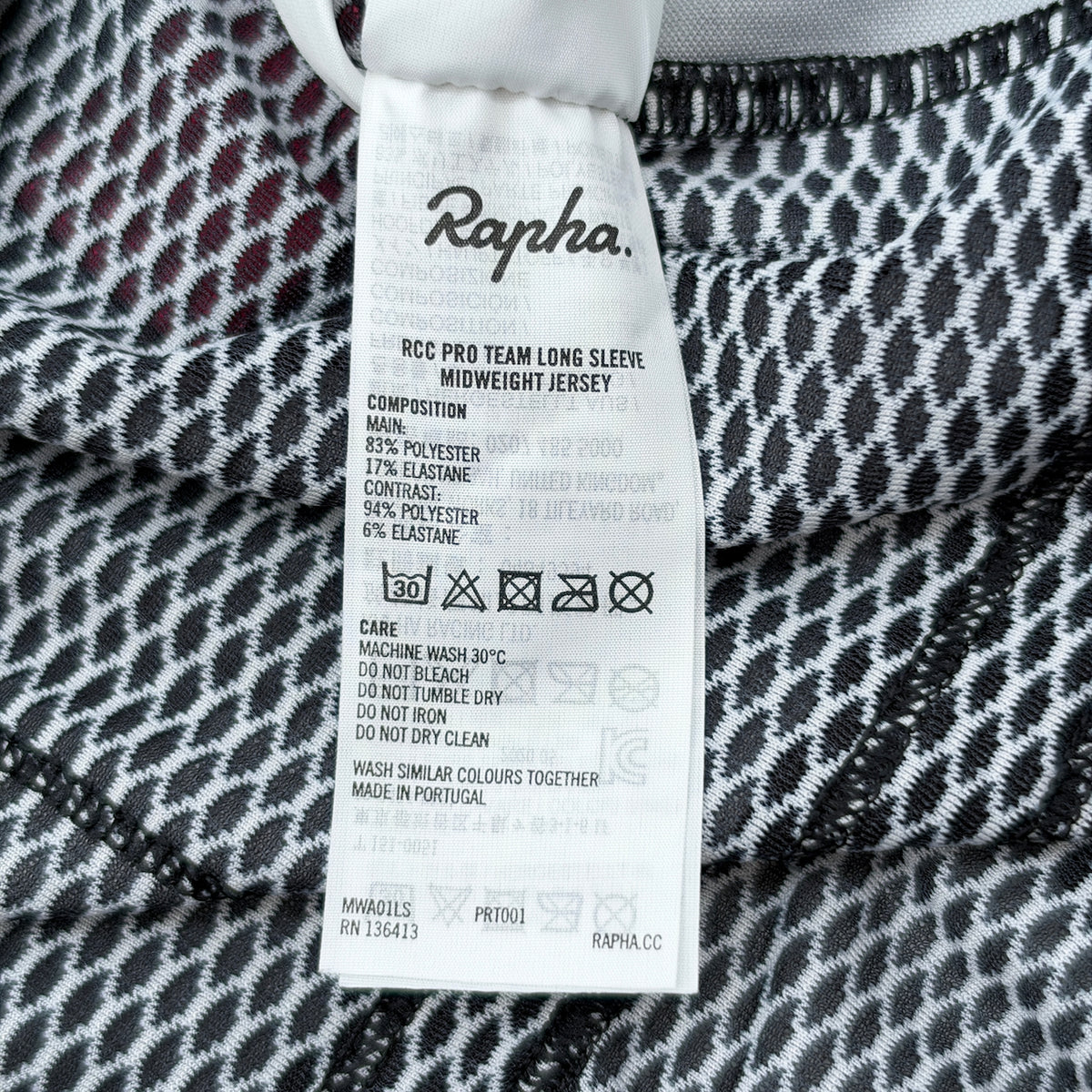 Care label showing RCC Pro Team Long Sleeve Midweight Jersey composition and wash instructions