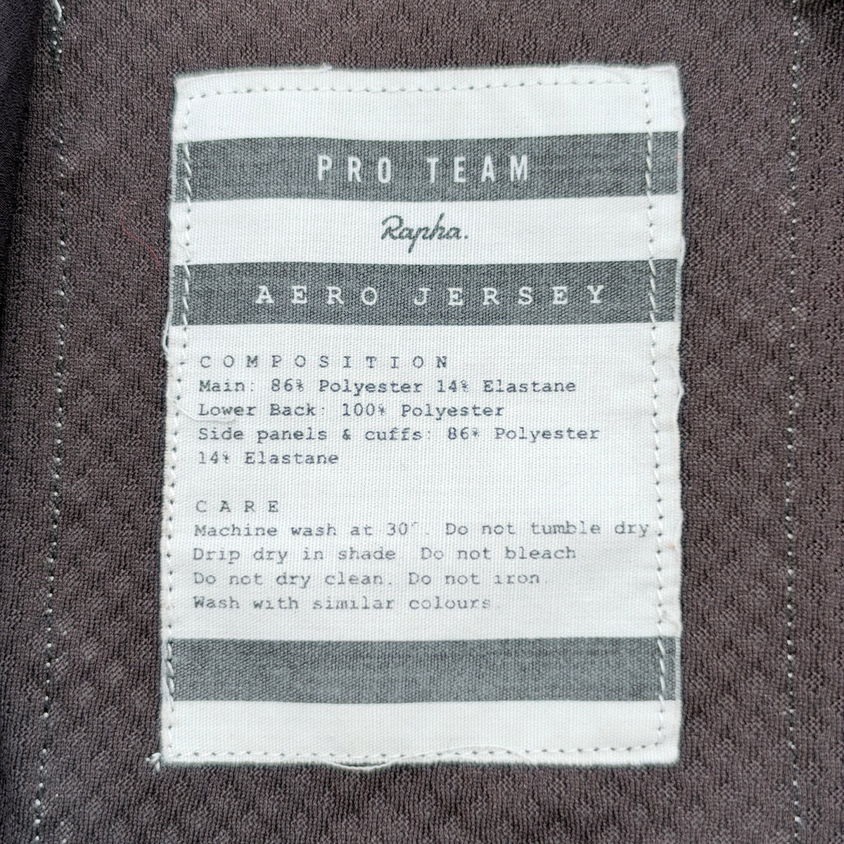 Woven Pro Team Aero Jersey care label showing composition and wash instructions