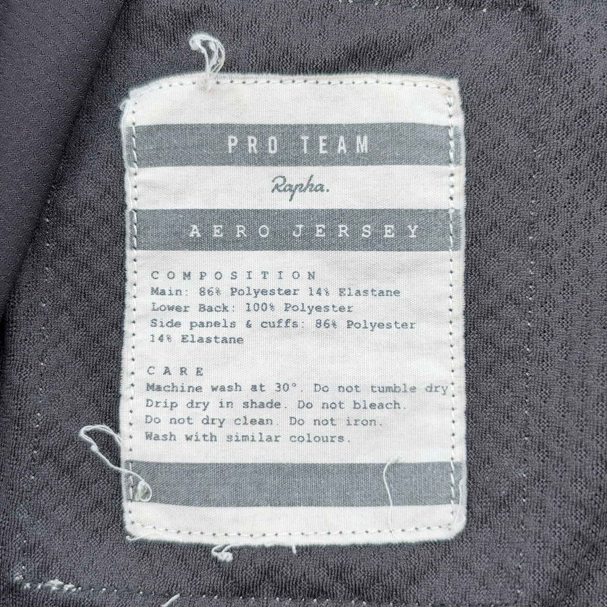 Woven Pro Team Aero Jersey care label showing composition and wash instructions