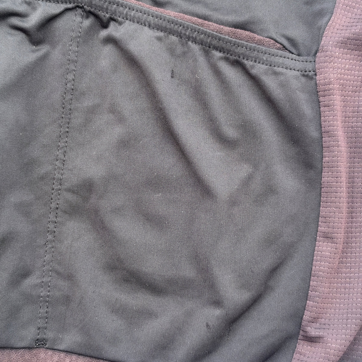 Close-up of the small race-number pin holes to the lower back, just below the pocket seam