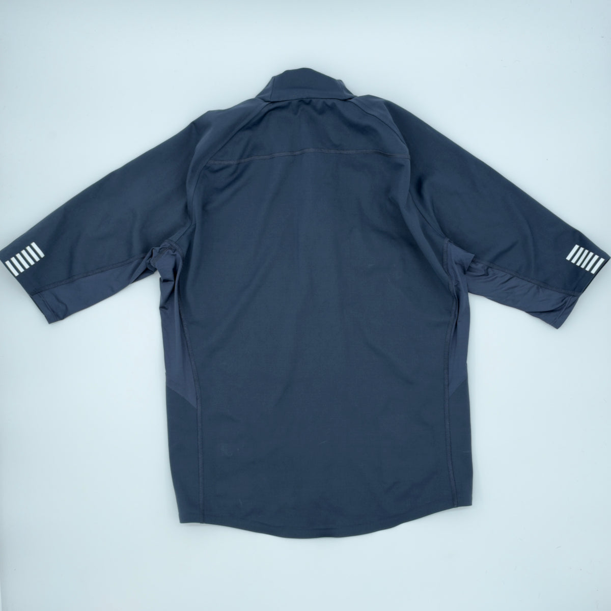 Rear view showing the pocketless back, raglan seams and reflective cuff motifs
