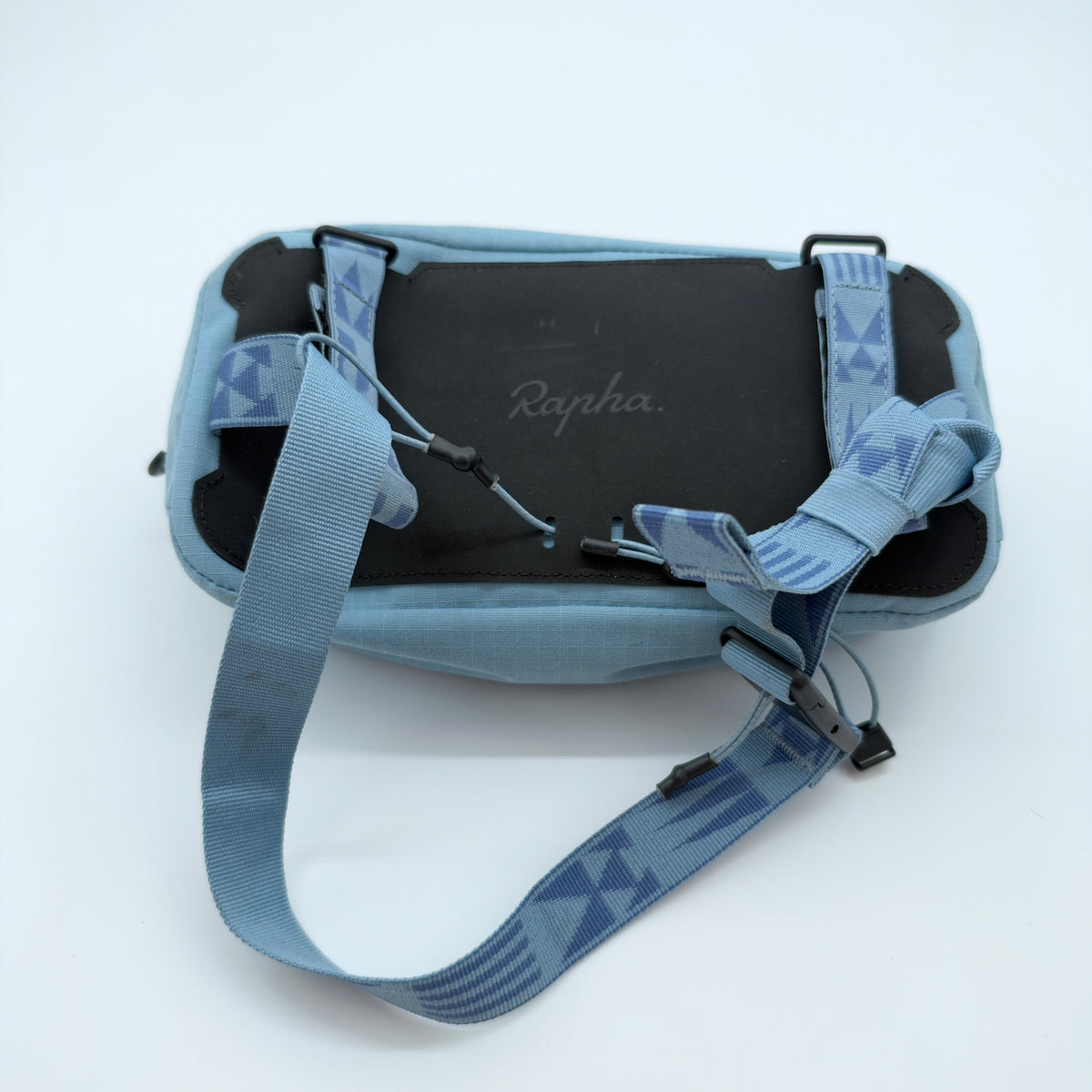 Rear view showing the moulded back panel, patterned mounting straps and shoulder strap