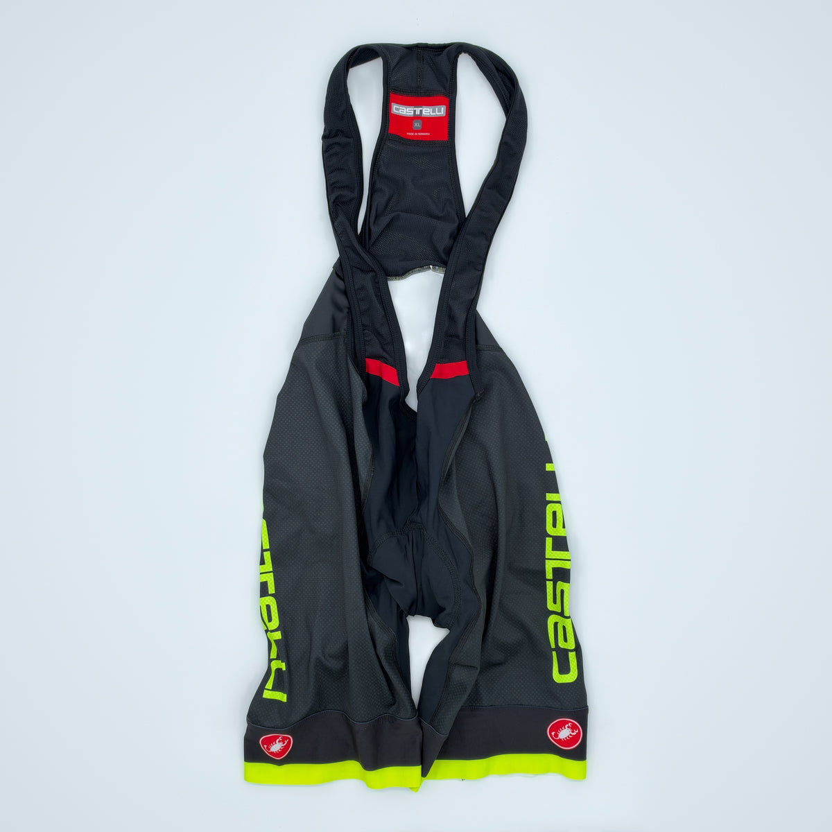 Castelli Competizione bib shorts flat front view in black and fluo yellow