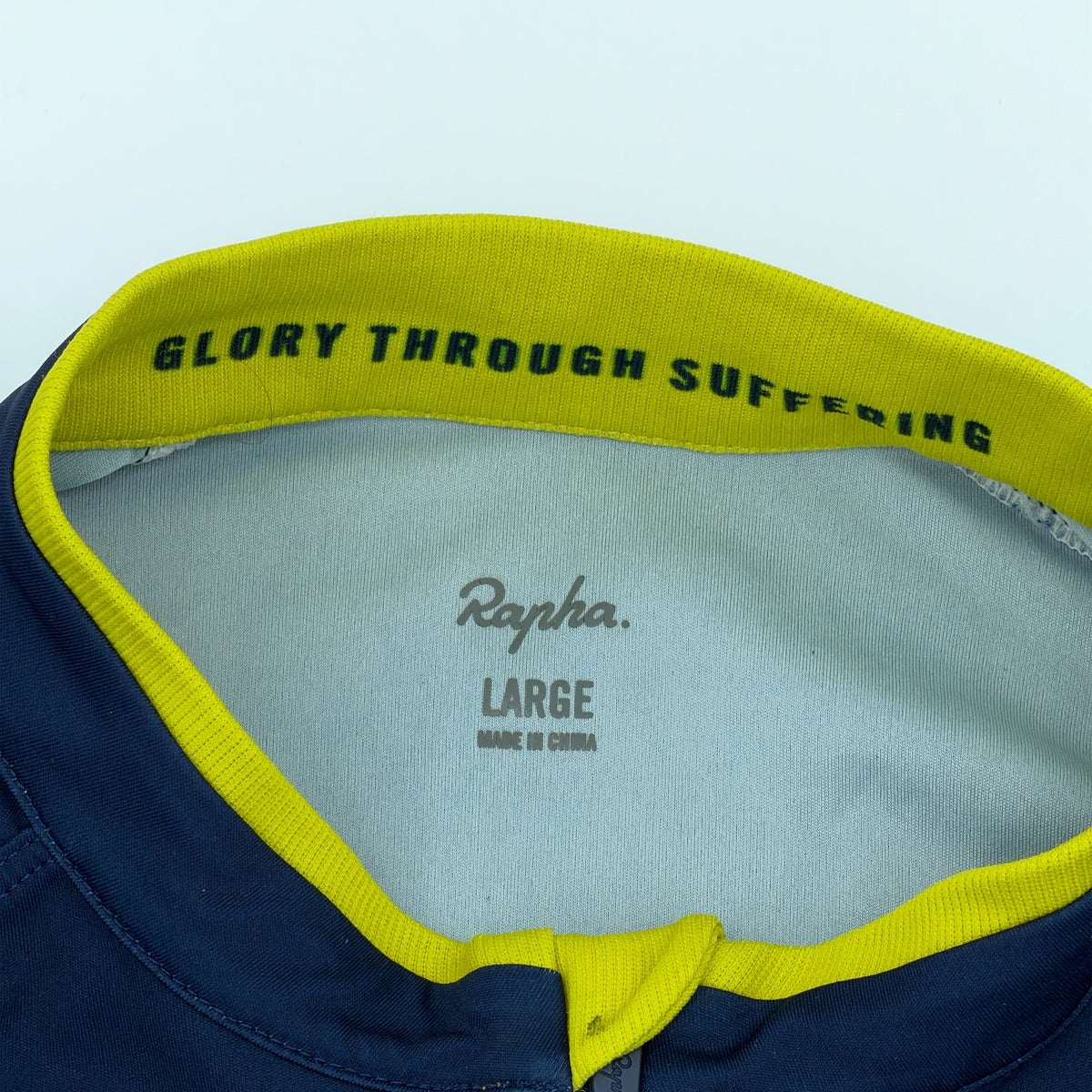 Collar print Glory Through Suffering and Rapha size label Large